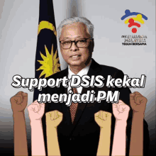 a man in a suit and tie stands in front of a flag and a sign that says support dsis kekal