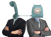 two men are standing next to each other with telephones in front of their faces