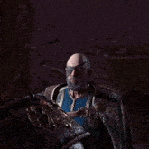 a man with a beard and a blindfold holds a stick