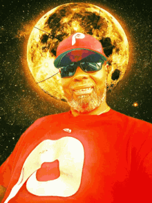 a man wearing sunglasses and a red shirt with the letter o on it