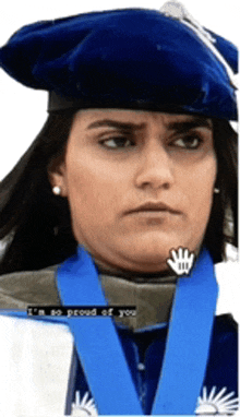 a woman wearing a graduation cap and gown with a medal around her neck says i 'm so proud of you