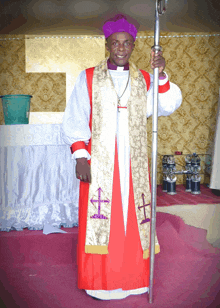 a man in a purple hat holds a pole in front of a gold cross