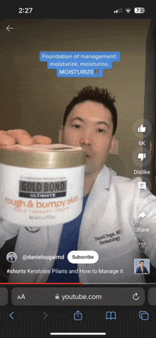 a doctor is holding a jar of gold bond ultimate rough & bumpy skin