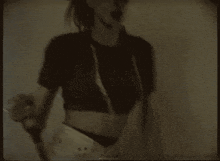 a black and white photo of a woman in a crop top and underwear