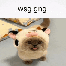 a cat wearing a cow costume with the word wsg gng above it .