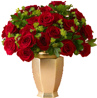 a vase filled with red roses and green leaves