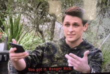 a man holding a cell phone with the words you got it ranger rick on the screen