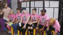 a group of people wearing pink tie dye shirts with the word cloud on it