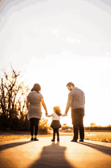 a family walking down a path holding hands