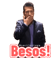 a man in a suit is covering his mouth with his hand and the words besos are above him