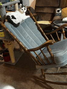 a cat laying on top of a rocking chair