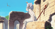 a woman in a white dress is sitting on a brick wall with a sword in front of her