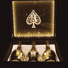 three bottles of ace of spades champagne are in a box