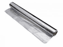 a roll of aluminum foil is sitting on top of a white surface .