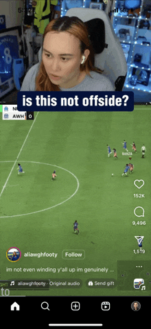 a woman is watching a soccer game on a cell phone with a caption that says is this not offside