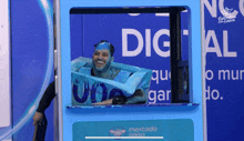 a man with blue paint on his face is in a box with the word dig on it