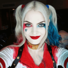 a woman in a harley quinn costume is smiling