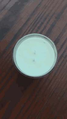 a white candle with two blue candles in it