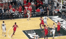 a basketball game is being played on a court with a banner that says ' buckeyes ' on it .