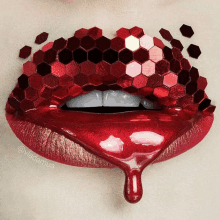 a close up of a woman 's lips with red lipstick and red sequins on them