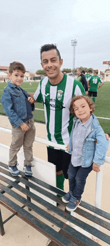 a man wearing a green and white striped jersey with the number 10 on it