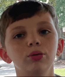 a close up of a young boy 's face with the letters c and j visible