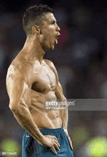 a shirtless soccer player is celebrating a goal during the match .