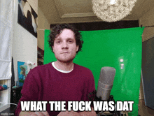 a man standing in front of a green screen with the words " what the fuck was dat "