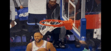 a basketball player with the letter o on his jersey is dunking the ball