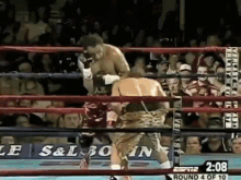 two boxers are fighting in a boxing ring with a sign that says espn on it .