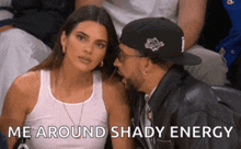 a woman sitting next to a man with the words me around shady energy above her