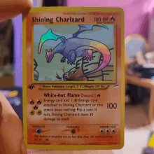 a shiny charizard pokemon card with a rainbow tail