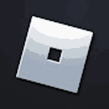 a white square with a black square in the middle on a dark background .