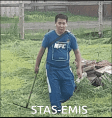 a man wearing a kfc shirt is walking through a grassy field