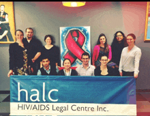 a group of people holding a banner that says halc