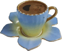 a cup of coffee sits on a saucer with a flower design