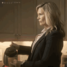 a woman in a suit is pouring coffee into a cup with the hashtag diggstown