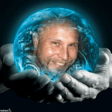 a man is holding a blue globe in his hands with imikimi.com written on the bottom