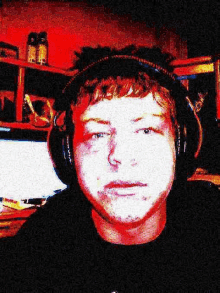 a man is wearing headphones and looking at the camera