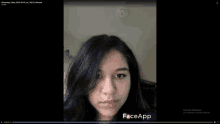 a video of a woman 's face with faceapp written on the bottom