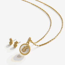 a gold necklace and earring set with a pendant that says ' i love you ' on it