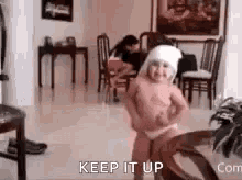 a little girl is dancing in a living room with the words `` keep it up '' written above her .