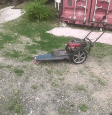 a lawn mower with a red honda engine on it