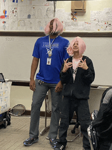 a man wearing a tennis shirt stands next to a woman wearing pink hair