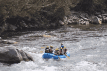 a group of people are in a raft in the water