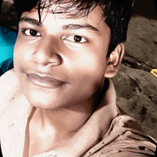 a close up of a young man 's face with a smile