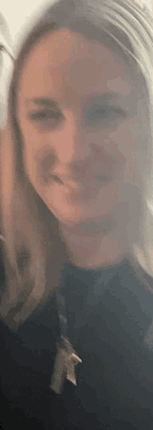 a close up of a woman 's face with a blurred background .