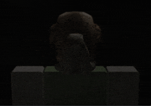 a statue of an owl is sitting on top of a green block in the dark