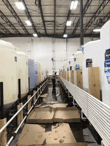 a warehouse filled with lots of white tanks