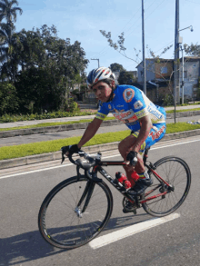 a man is riding a bicycle with a shirt that says ' tailor ' on the front